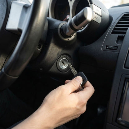 Hand inserting ignition key into a Nissan Titan